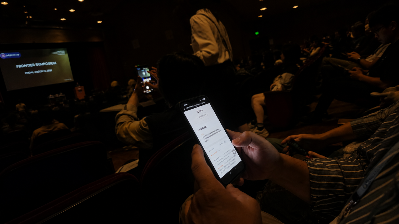 Attendee using Intent Live Caption for real-time multilingual transcription during the AASF Frontier Symposium at Stanford University.